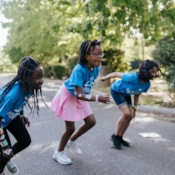 Three girls in blue Girls on the Run tshirts running
